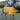 Dog wearing yellow Pouty Paws drying robe standing outdoors by vehicle after adventure