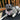 Dog wearing Pouty Paws Squirrel Chaser bandana relaxing on patio