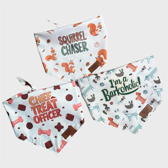 Pouty Paws reversible dog bandanas 3 pack showing Squirrel Chaser, Barkoholic, and Chief Treat Officer designs